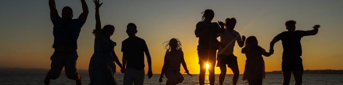 Family jumping sunset on a beach
